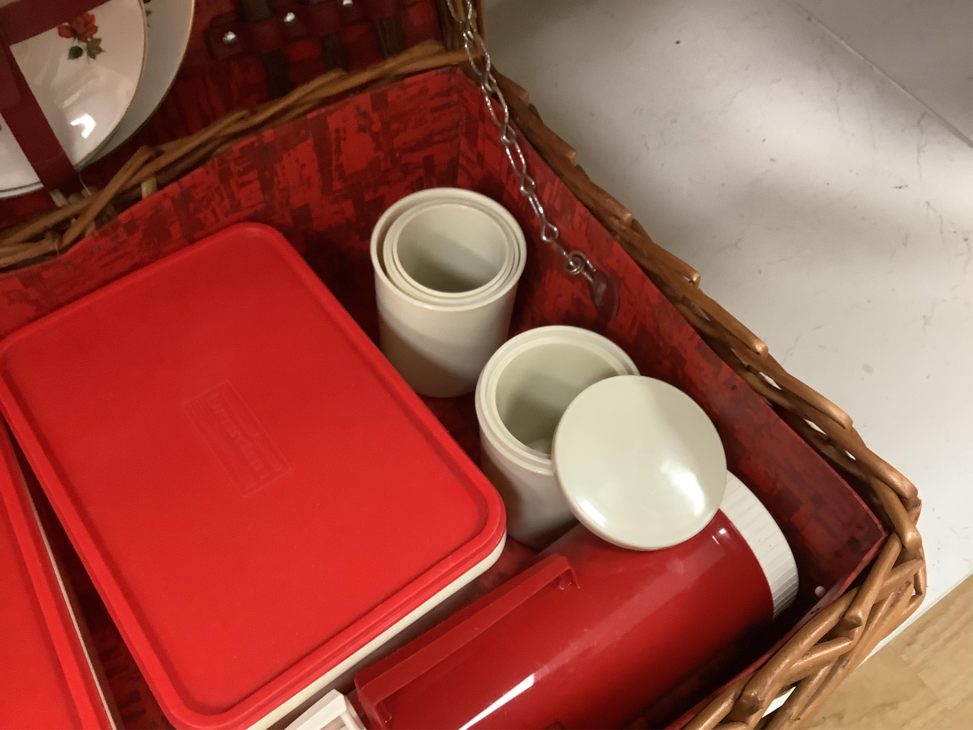An Asprey wicker picnic basket, fully fitted with contents
